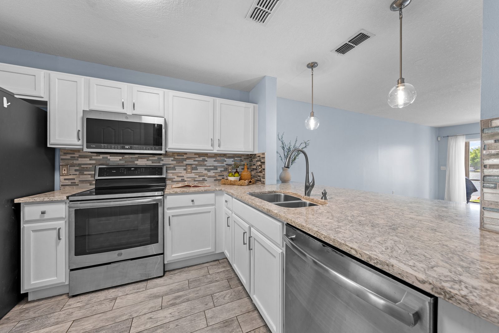 Kitchen with range and quartz counters